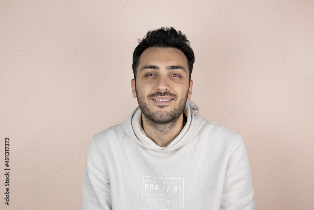 Happy smiling young boy on soft orange isolated background. Faacial expressions and gesturing. Happy smiling young boy on soft orange isolated background. Faacial expressions and gesturing.