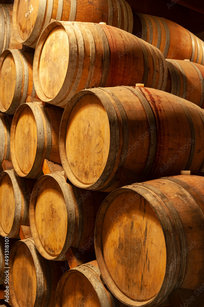Oak wine barrels in a winery, Napa Valley, California, USA