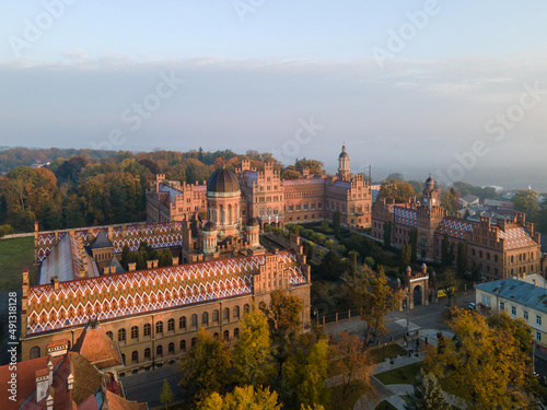 City panorama from the air, shot from a drone. Yury Fedkovych national University in Chernivtsi. City morning landscape with foggy haze. UNESCO monument in Ukraine