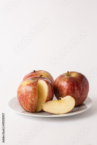 ripe red apples on a plate, white background