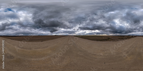 360 seamless hdr panorama view on gravel road with clouds in gray overcast  sky before storm in equirectangular spherical projection, ready AR VR virtual reality content photo