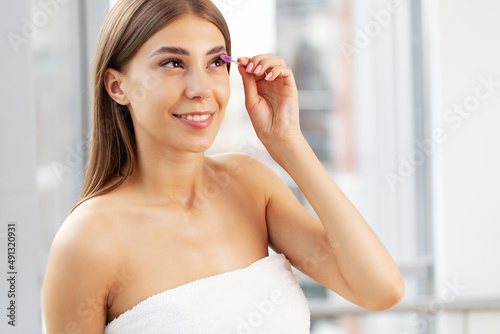 Free Download Beautiful young woman applying makeup in morning - GFXLoad