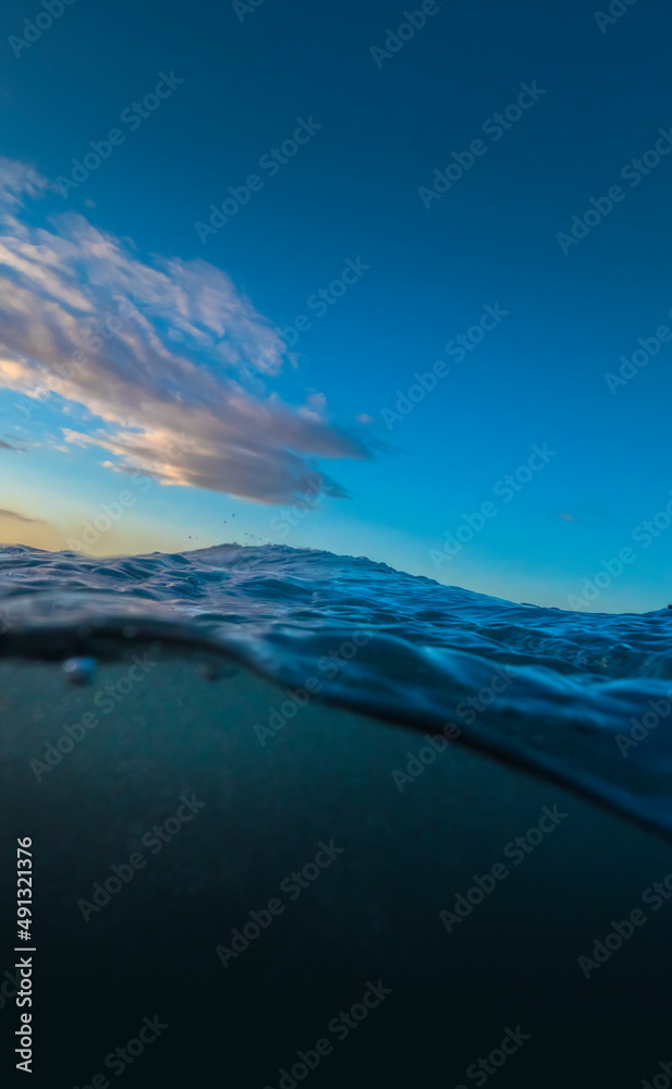 Under Over OCean waters with blue sky