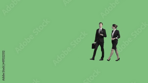 A man and a woman in business suits walk through the frame. Perspective view. 85mm lens