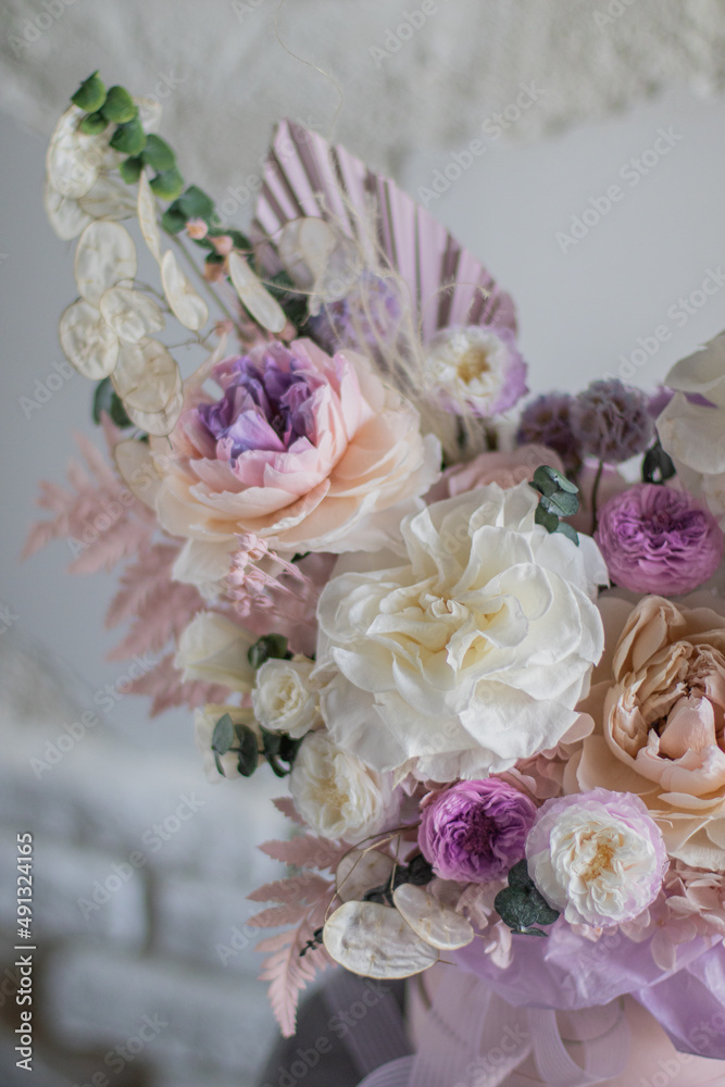 A luxurious bouquet of flowers in a hat box. Composition with pink and white flowers and eucalyptus in a round box. Modern Floristry. A luxurious bouquet of flowers in a hat box. Composition with pink and white flowers and eucalyptus in a round box. Modern Floristry.