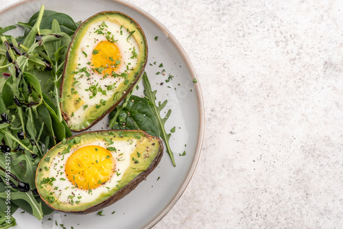 Healthy breakfast. Avocado stuffed with eggs on the table