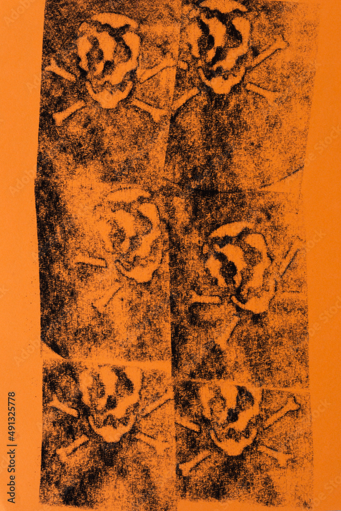 pastel chalk impression of skull and bones on orange paper