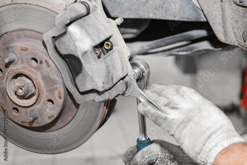 Closeup disc brake of the vehicle for repair in garage.