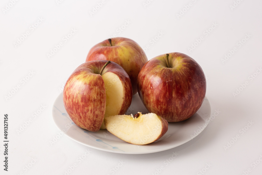 ripe red apples on a plate, white background ripe red apples on a plate, white background