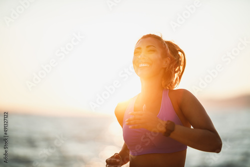 Fototapeta Naklejka Na Ścianę i Meble -  Woman Jogging Along The Sea Shore