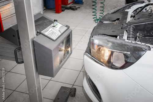 Auto repair service. Adjusting the car headlight light © ierehon74