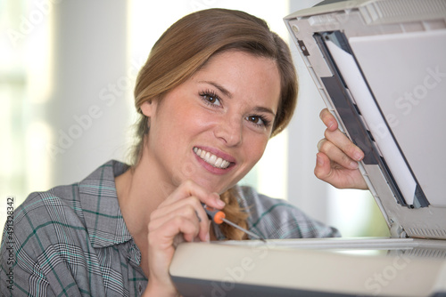 young woman doing printer maintenance