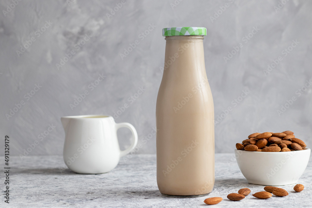Almond milk on the table. Vegan plant-based product. Healthy food concept, lactose free food. Selective focus Almond milk on the table. Vegan plant-based product. Healthy food concept, lactose free food. Selective focus