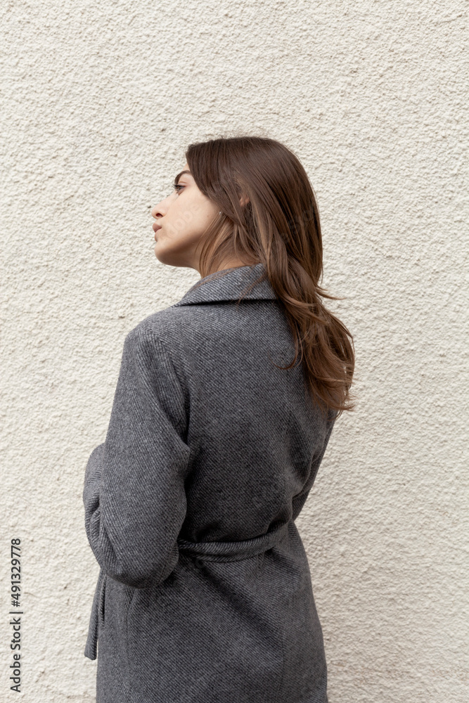 beautiful girl in a stylish coat posing on the street beautiful girl in a stylish coat posing on the street