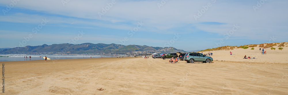 Fototapeta premium Cars on the beach. Oceano Dunes, California Central Coast, the only California State Park that allows vehicles to drive on the beach