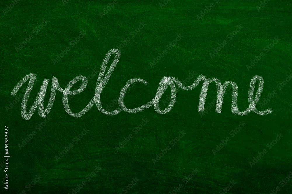 Welcome Sign handwritten with chalk on School Board Welcome Sign handwritten with chalk on School Board