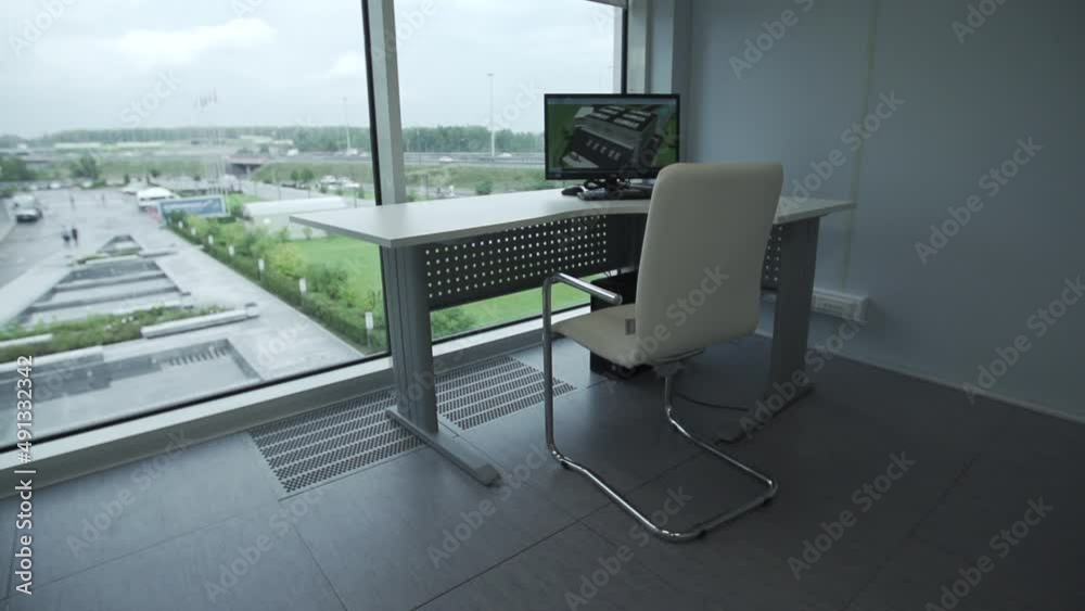 Minimal background image of empty office workplace by window with white desk behind glass wall, copy space. Lost work, unemployment, economic crisis concept.
