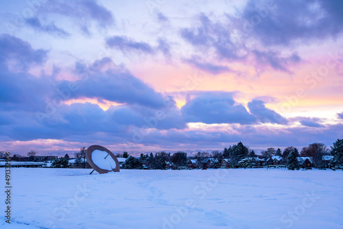 Canvas Print Winter sunset scene at Cranmer Park in the Hilltop neighborhood in Denver, Colorado with its iconic Sundial and view of the mountain range in the distance