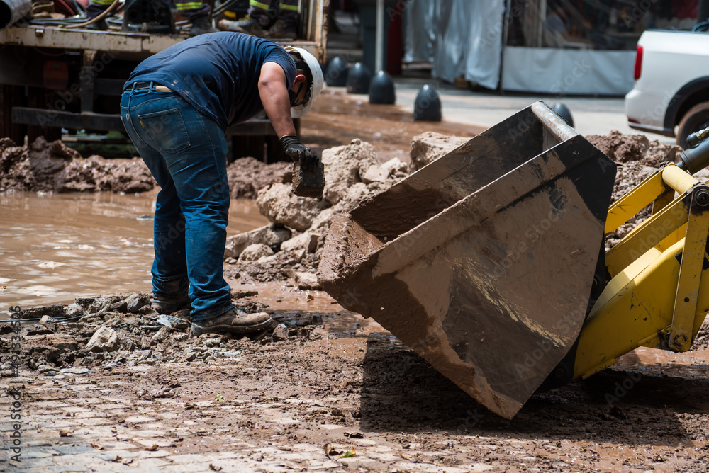 construction worker moving stone debris by hand construction worker moving stone debris by hand