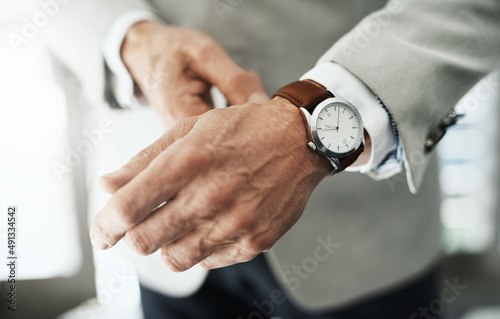 Accessories are part of the look. Closeup of an unrecognizable businessman attaching a watch to his wrist at home during the day.