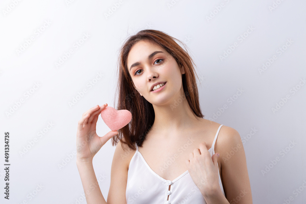 Beautiful smiling woman with clean skin, natural make-up and white teeth on a gray background Beautiful smiling woman with clean skin, natural make-up and white teeth on a gray background