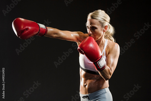 Studio shot of athlete woman boxing