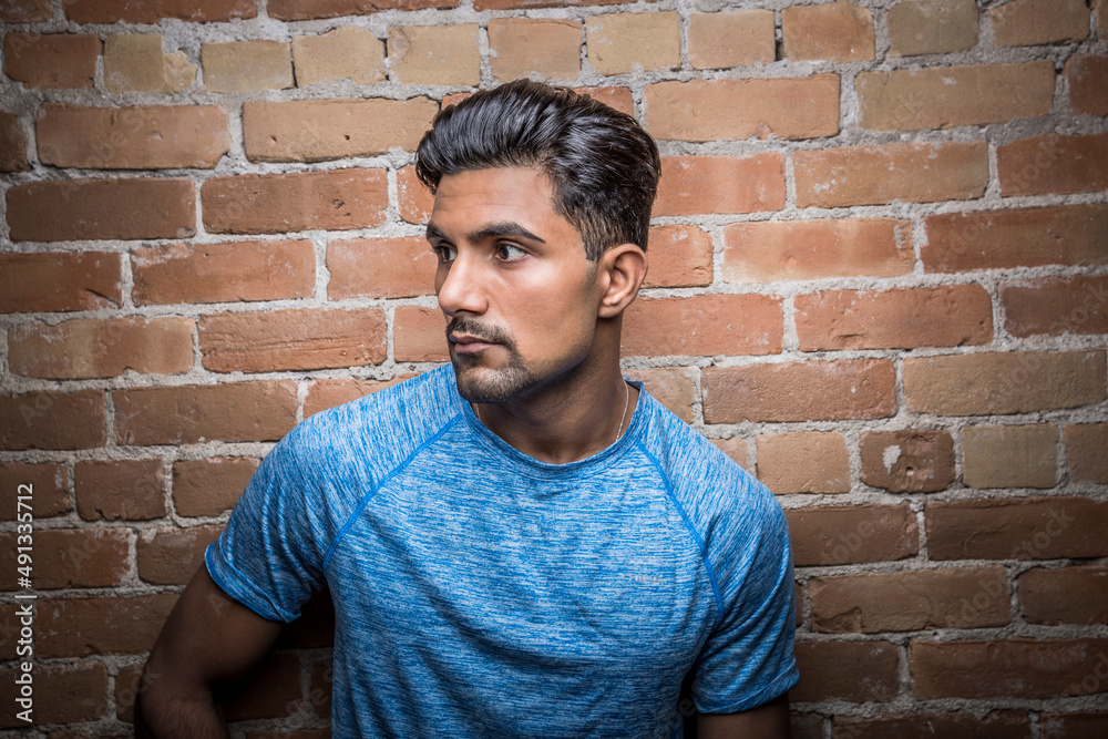 Portrait of serious man against brick wall Portrait of serious man against brick wall