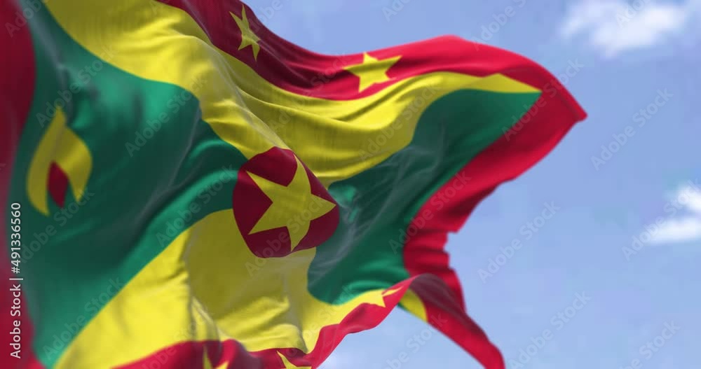 Detail of the national flag of Grenada waving in the wind on a clear day
