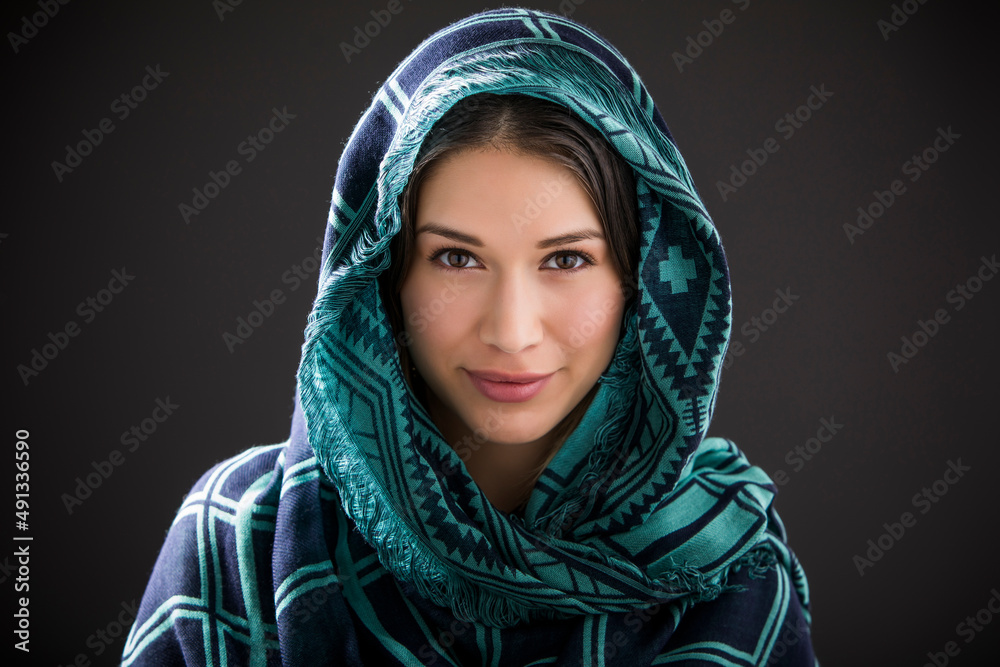 Studio portrait of smiling woman with shawl on head Studio portrait of smiling woman with shawl on head