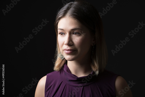 Studio portrait of woman in sleeveless purple top photo
