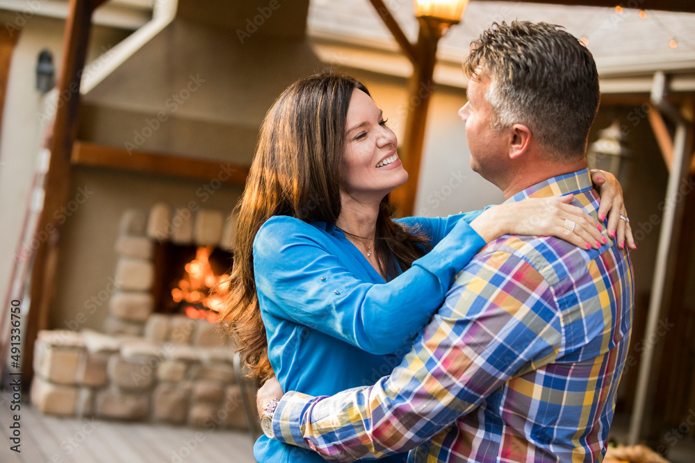 Mature couple dancing by fireplace Mature couple dancing by fireplace