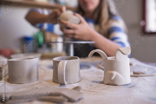 woman making ceramic handicrafts on a table