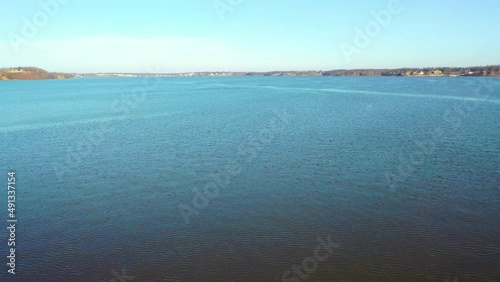 Flying Over Calm Blue Water With Ripples From Wind On Lake Of The Ozarks in Midwest Missouri At Daytime - aerial drone shot photo