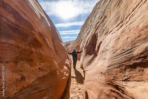 United States, Utah, Escalante, Senior hiker walking in sandstone canyon