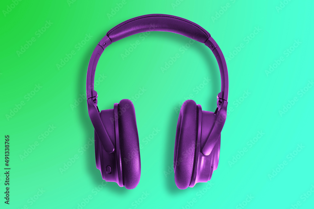 Computer headphones. Violet headphones on a white background. The concept of listening to music, creating audio, music. Computer work, abstraction and minimalist style. Computer headphones. Violet headphones on a white background. The concept of listening to music, creating audio, music. Computer work, abstraction and minimalist style.