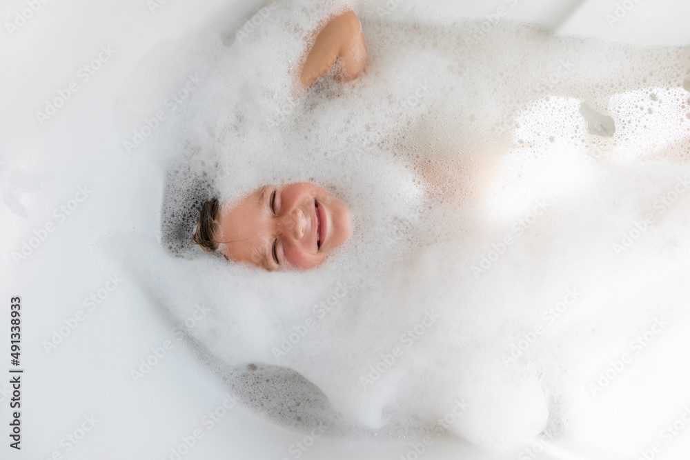 Boy (8-9) in bubble bath Boy (8-9) in bubble bath