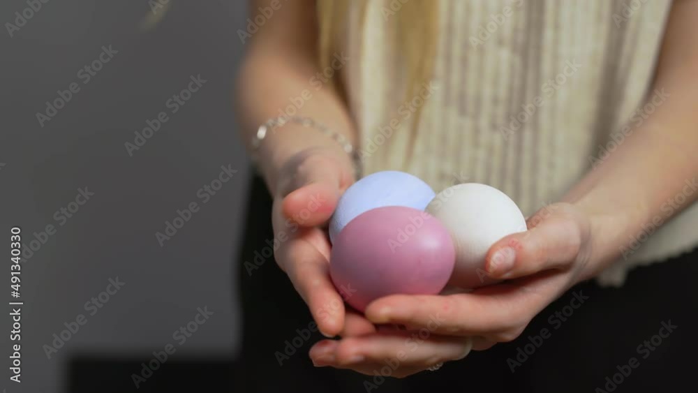 Close-up of female hands holding Easter eggs. Christ is risen. Church holiday-Easter Close-up of female hands holding Easter eggs. Christ is risen. Church holiday-Easter