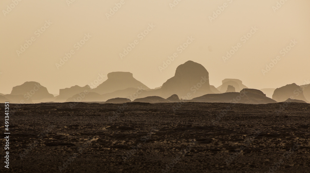 Evening view of the silhouettes of rock formations in the Western Desert, Egypt