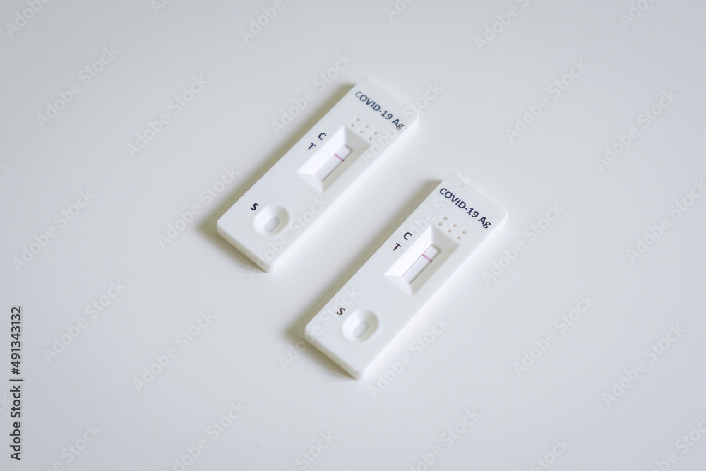 Two units of RTK Antigen Covid test kit on white table. Two units of RTK Antigen Covid test kit on white table.