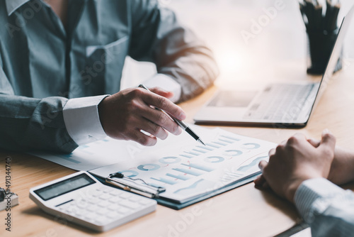 Business people discussing contract working together at meeting in modern office. Unknown businessman and woman with colleagues or lawyers at negotiation