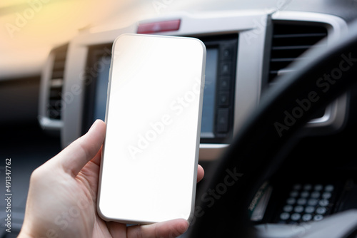 Hand hold blank mobile phone in car for technology