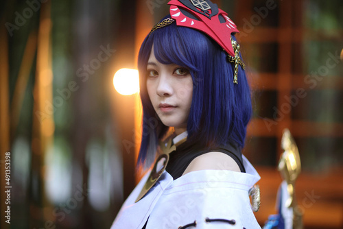 Japanese young woman hunter cosplay with bow on Japanese garden