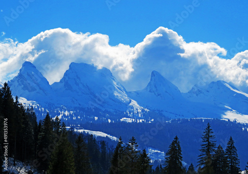 Magical winter clouds over snowy peaks of the Swiss alpine mountain range Churfirsten (Churfürsten or Churfuersten) in the Appenzell Alps massif - Unterwasser, Switzerland (Schweiz)