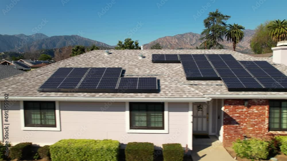 Solar panels generating efficient, clean energy on homes - sliding aerial view Solar panels generating efficient, clean energy on homes - sliding aerial view