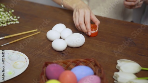 Close-up on a table with items to create a composition for Easter. Women's hands arrange objects on the table. Church holiday-Easter
