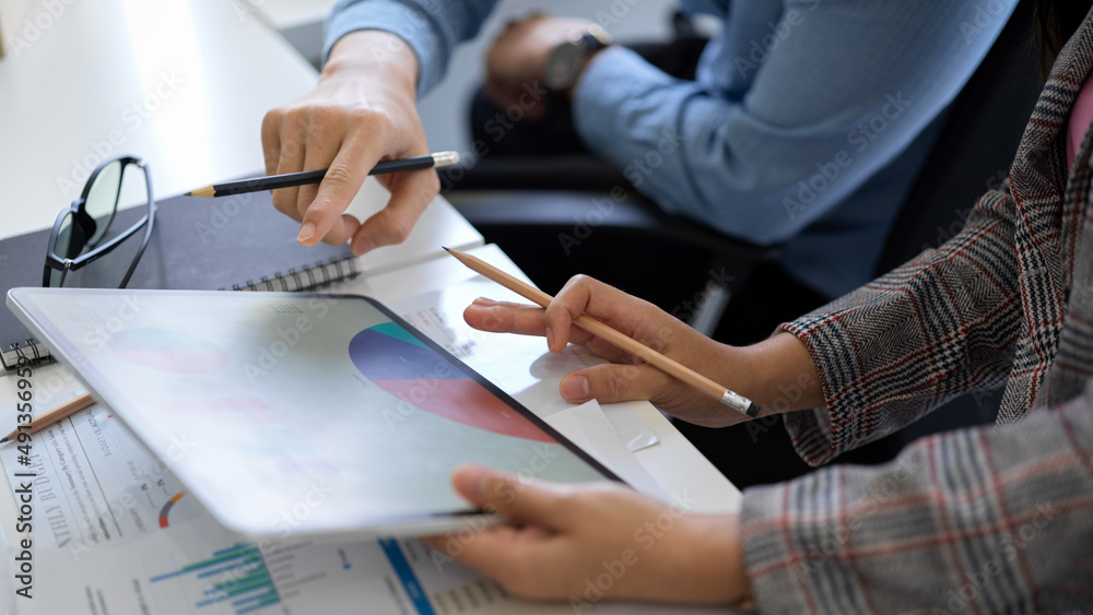 Female boss and marketing officer checking the report