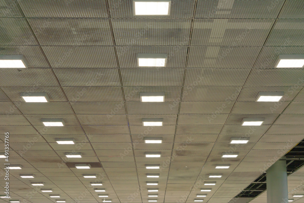 Ceiling of corporate office with lights in office building. System work. Modern style. Ceiling of corporate office with lights in office building. System work. Modern style.