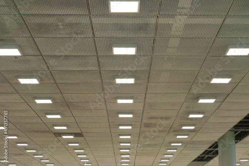 Ceiling of corporate office with lights in office building. System work. Modern style.