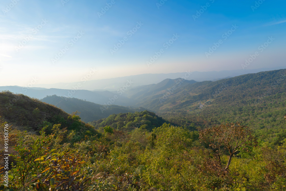 Aerial top view of forest trees and green mountain hills with fog, mist and clouds. Nature landscape background, Thailand. Aerial top view of forest trees and green mountain hills with fog, mist and clouds. Nature landscape background, Thailand.
