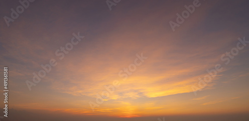 Sunset sky. Abstract nature background. Dramatic blue with orange colorful clouds in twilight time. © tampatra